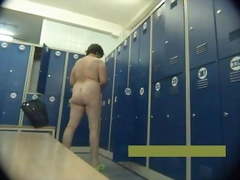 Middle-aged mother undresses in locker room